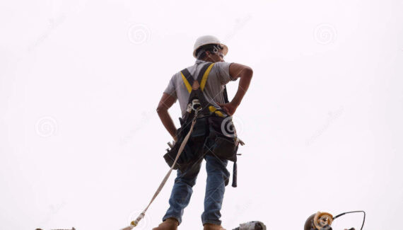hispanic-carpenter-standing-roof-his-tools-wearing-safety-harness-hard-hat-new-construction-home-pneumatic-41003709
